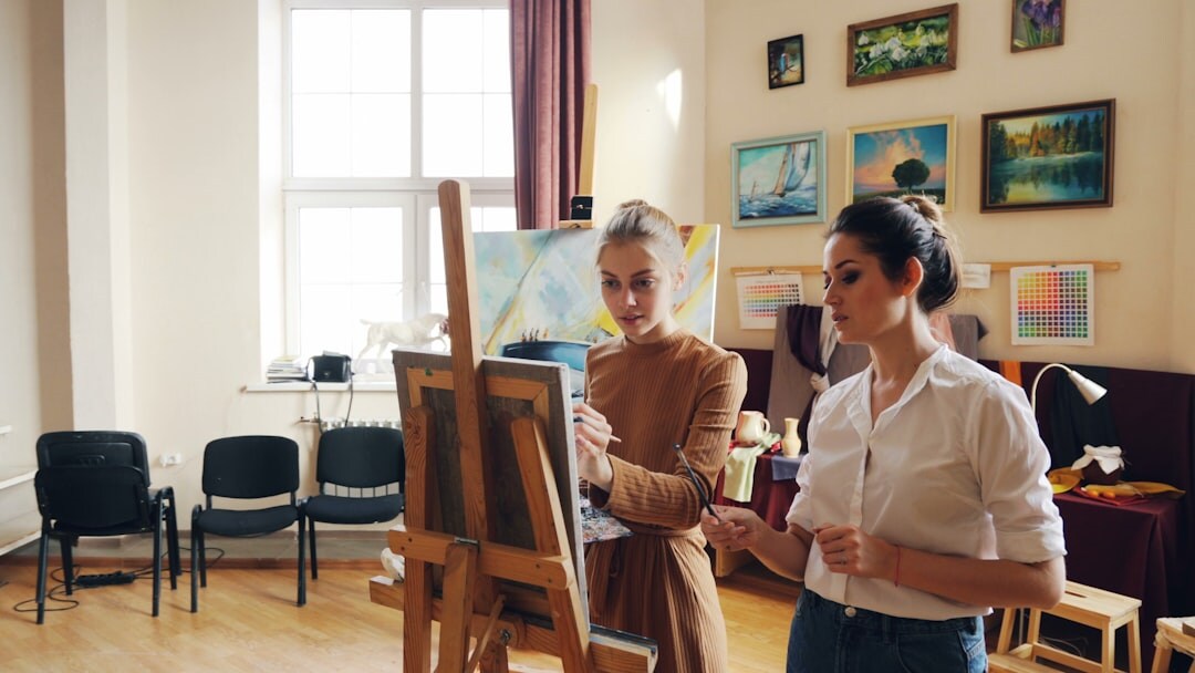 Seniors painting together in an art workshop class