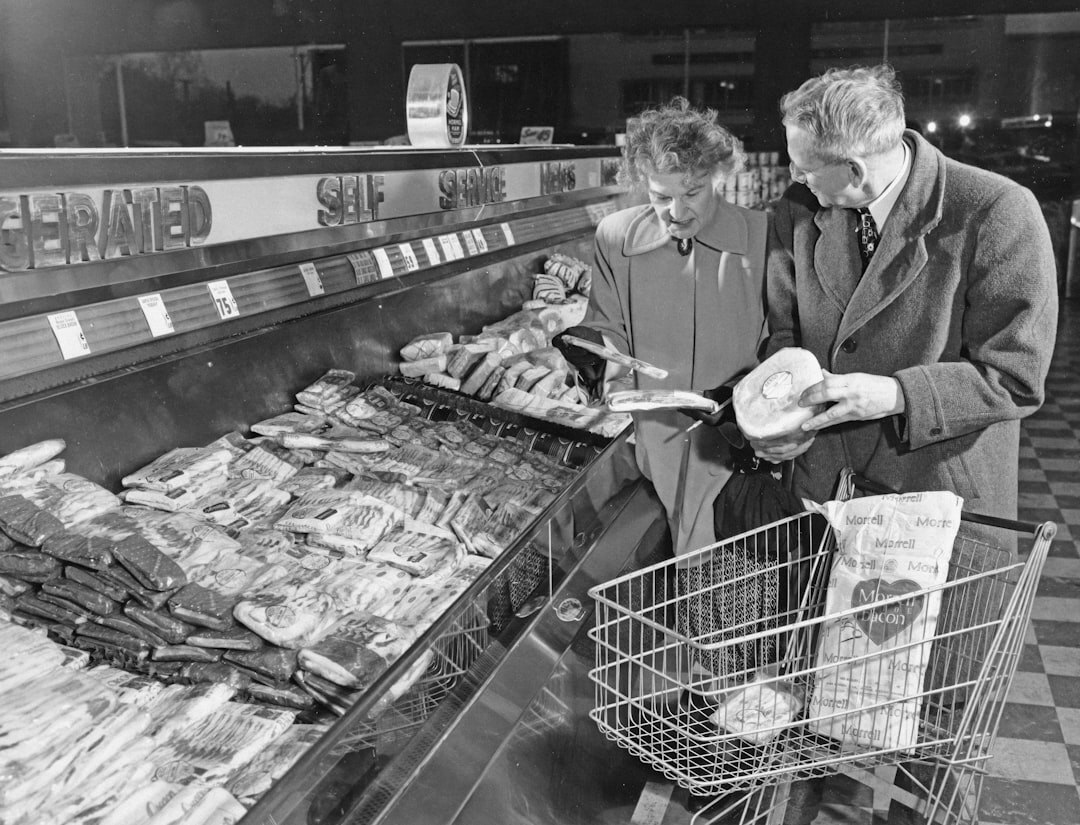 Senior couple shopping and holding a discount coupon in a store