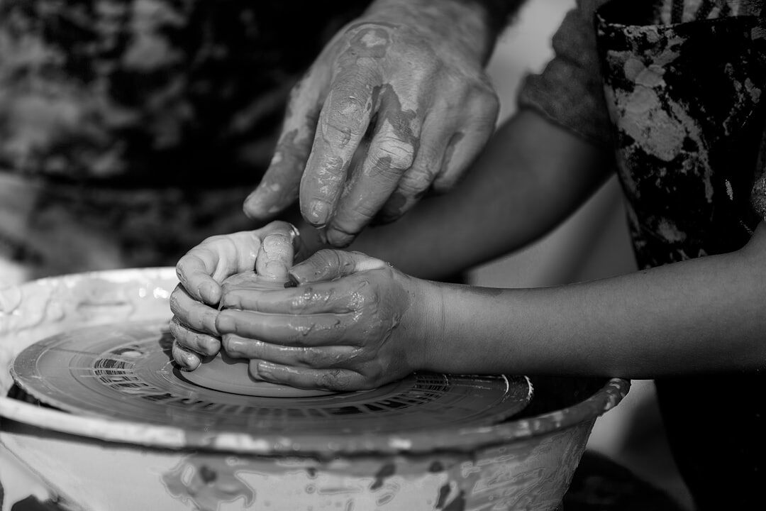 elderly hands shaping clay